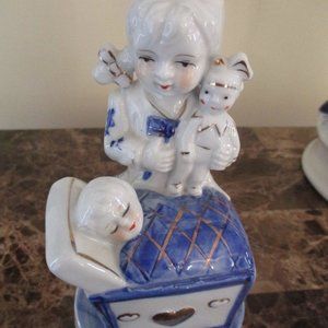 Vtg. Porcelain Blue/White Girl Holding Doll/Watching Baby in Cradle Figurine